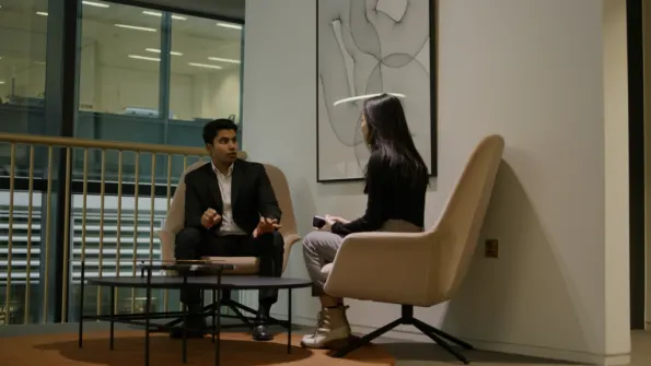 two business analysts conversing in office